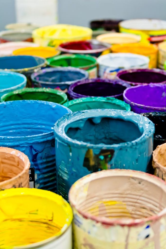 assorted-color-paint-buckets-1887946 A vivid assortment of open paint cans displaying a spectrum of colors, ideal for artistic and design projects.