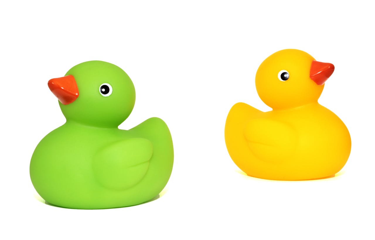 brand-01 Green and yellow rubber duck toys isolated on a white background.
